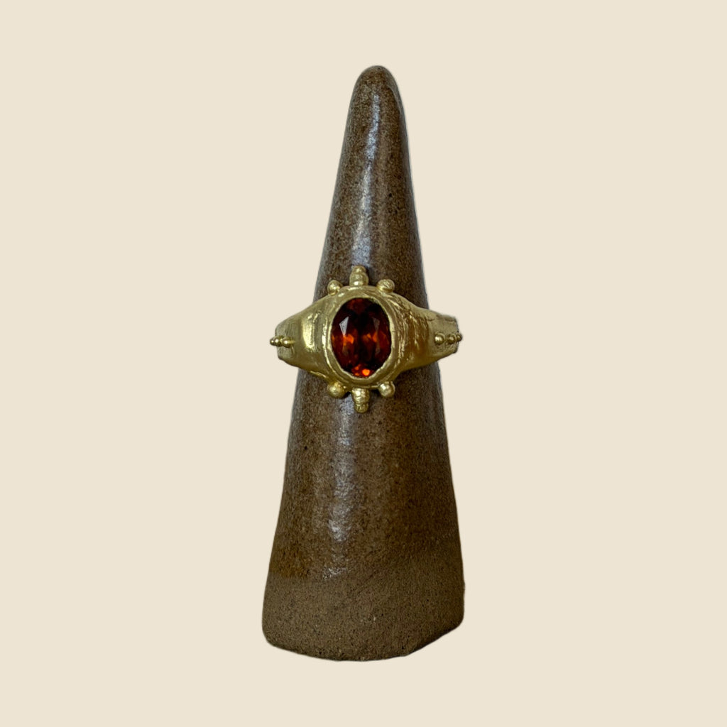 Hessonite ring on stand