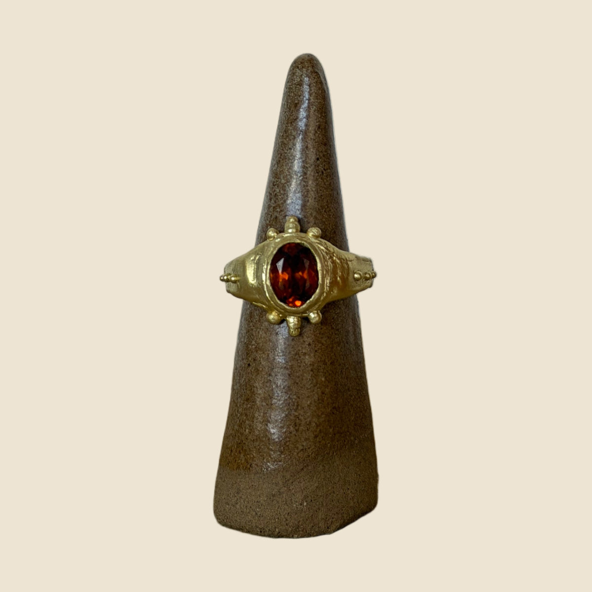 Hessonite ring on stand